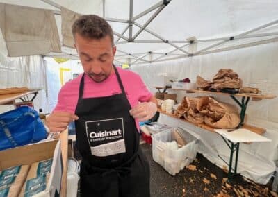 Bénévole servant des repas sous un chapiteau