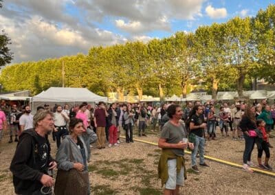 Festivaliers rassemblés sous les arbres en journée